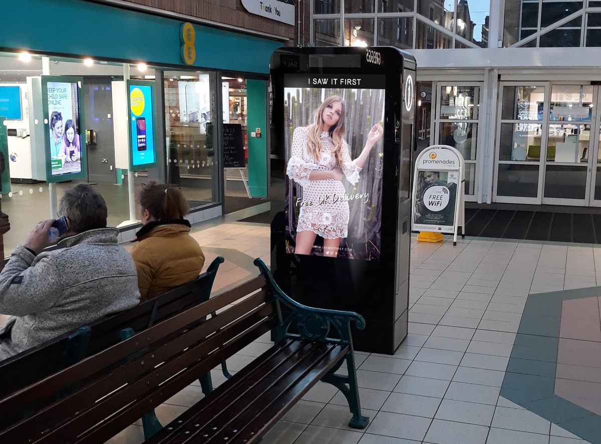 A portrait digital screen inside a shopping centre