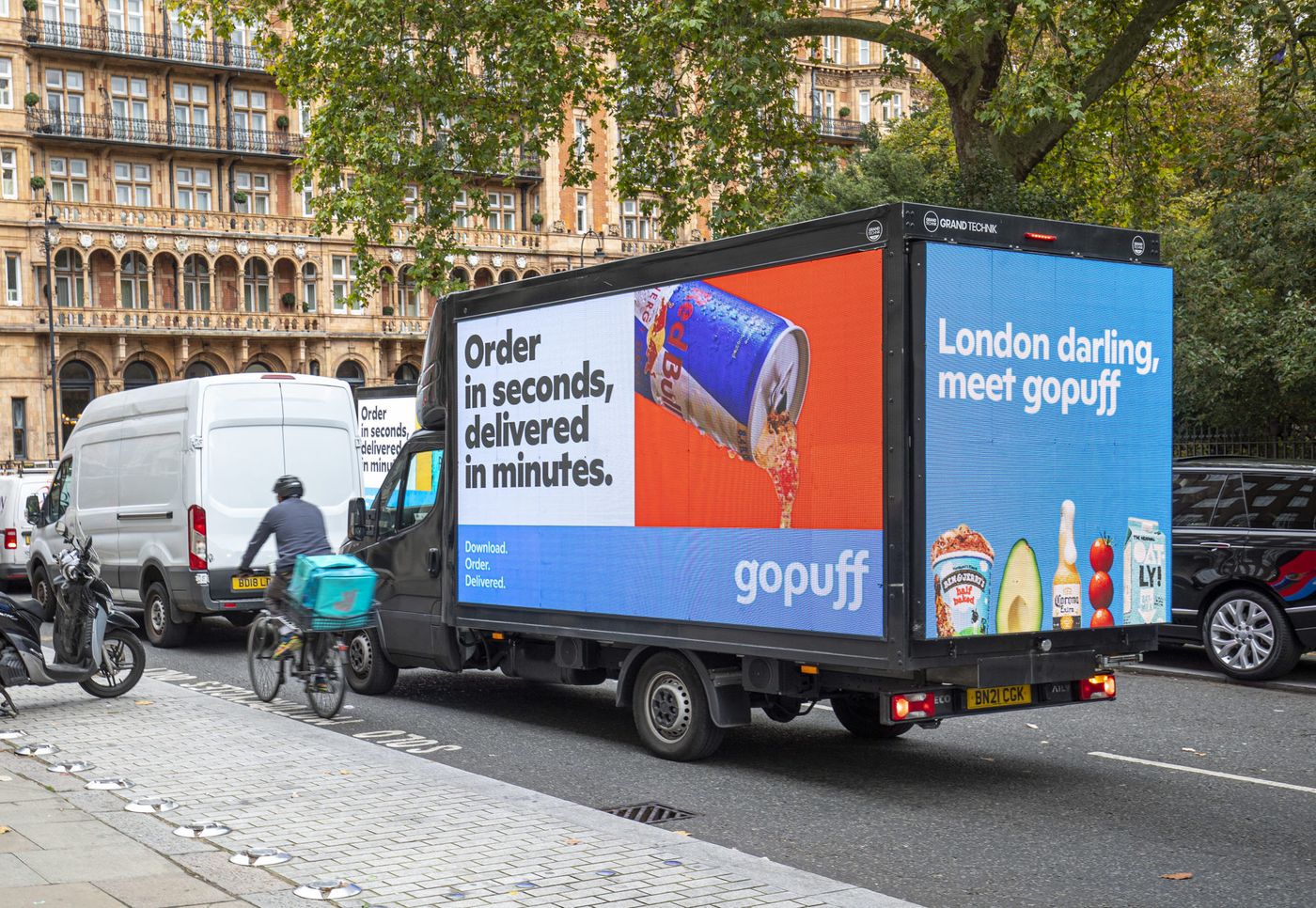 A digital advertising van with screens driving through London